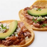 Carnitas Taco · Corn tortillas, Pork carnitas, melted Jack cheese, Enchilada sauce, onion-cilantro relish an...