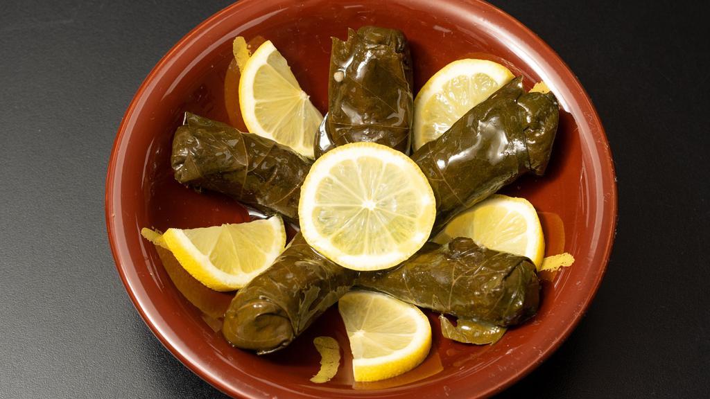 Stuffed Grape Leaves · Stuffed with a savory mixture of tomatoes, onions, rice and seasoning. Served with a side of pita bread.