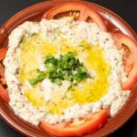 Baba Ganouj · Cooked eggplant mixed with onions, tomatoes, olive oil and various seasonings. Served with a...