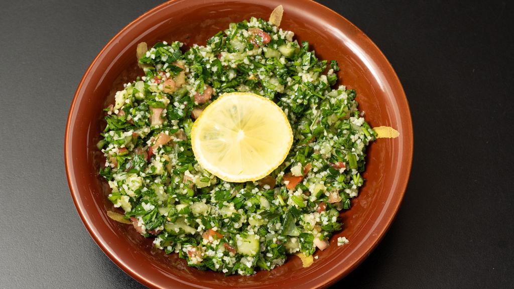 Tabouli Salad · Tomatoes, finely chopped parsley, mint, bulgur and onion and seasoned with olive oil, lemon juice and salt. Served with a side of pita bread.