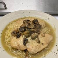 Chicken Scallopini · Sautéed chicken with mushrooms, in a butter white wine sauce, served over pasta.