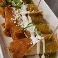 Banderillas Ahogados (6) · Crispy corn taquitos filled with chicken, topped with crema, green and red hot sauce, queso ...