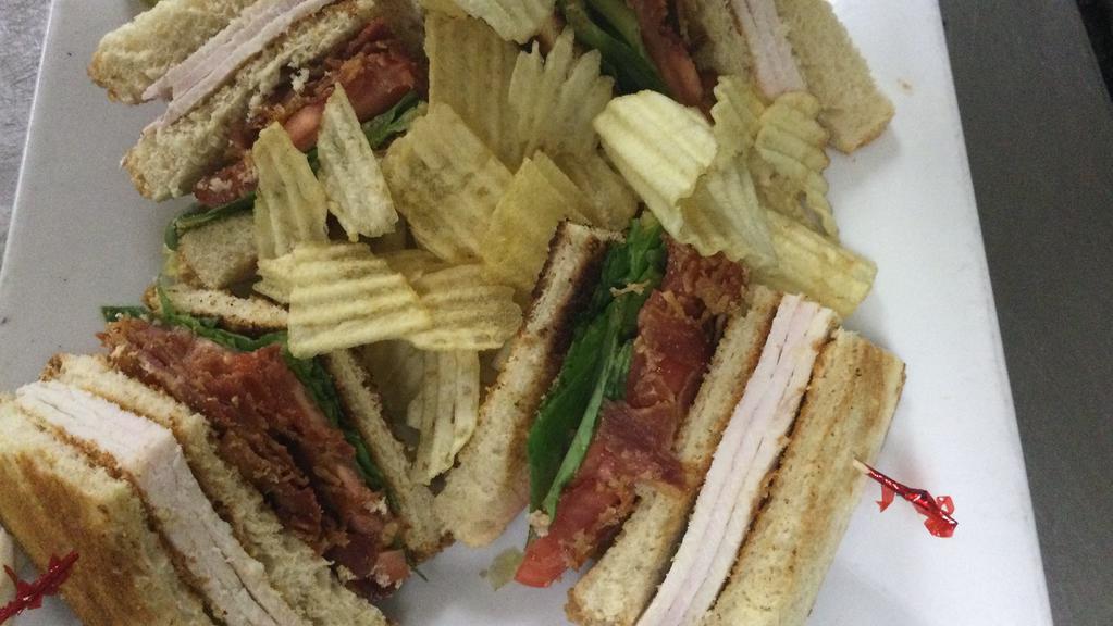 Turkey Club Sandwich · Hand carved turkey, crispy bacon, lettuce, tomato and mayo.