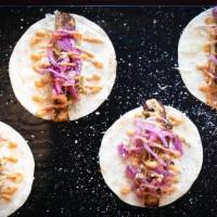 Blackened Fish Taco (2Pc) · Topped with cream cheese, homemade pickled onions & cabbage and cotija cheese