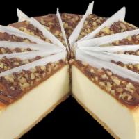 Turtle Cheesecake · Our golden brown cheesecake topped with caramel, walnuts and drizzled with chocolate.