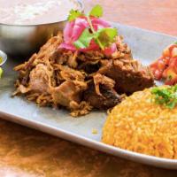Carnitas Michoacan · Flavorful pulled pork served with pinto beans, spicy salsa, fresh cilantro, and warm corn to...