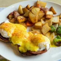 Eggs Benedict · Toasted english muffin topped with canadian bacon and two poached eggs drizzled with holland...