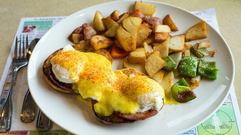 Eggs Benedict · Toasted english muffin topped with canadian bacon and two poached eggs drizzled with hollandaise sauce.