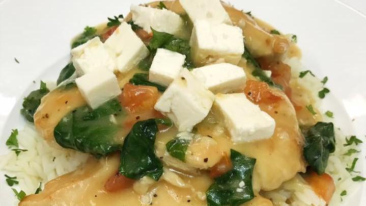 Chicken Athena · Sauteed chicken breast topped with tomatoes and spinach in a white wine garlic sauce and feta cheese over rice.