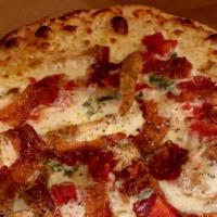 Chicken On The Ranch · White pizza (no red sauce) with mozzarella, chicken, bacon, tomatoes, ranch dressing and sca...