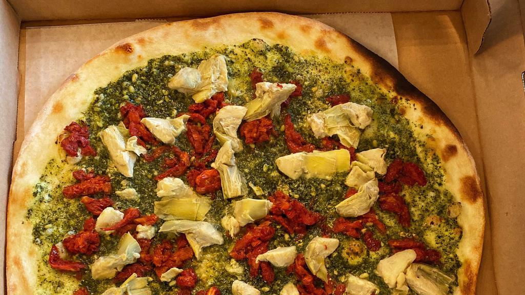 Veggie Pesto · Pesto, artichokes, sun-dried tomatoes, fresh garlic. This pizza does not have red sauce or mozzarella. There is cheese in the pesto.