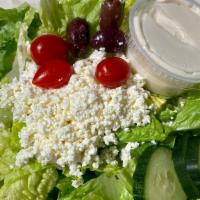 Greek Salad · Crisp romaine, tomatoes, cucumbers, feta cheese, kalamata olives, with Greek dressing on the...