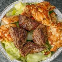 Combo Salad · Steak tips & chicken kabob on a garden salad.