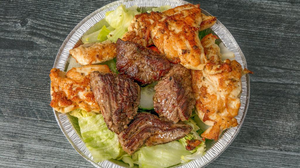 Combo Salad · Steak tips & chicken kabob on a garden salad.