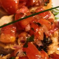 Bruschetta · Chopped plum tomatoes, red onions and basil marinated in olive oil, garlic and spices. Serve...