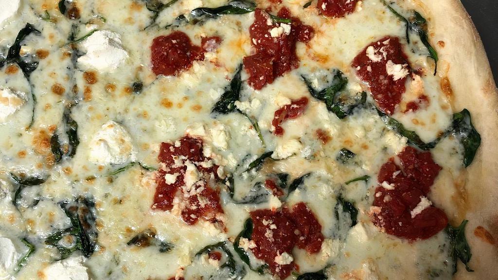 Mediterranean Pizza · Spinach, marinated tomatoes, garlic, olive oil, Mozzarella and Feta cheese.