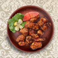 Clay Pot Chicken Tikka · Tender, juicy boneless chicken cubes marinated in a spicy tandoori marinade, skewered and gr...