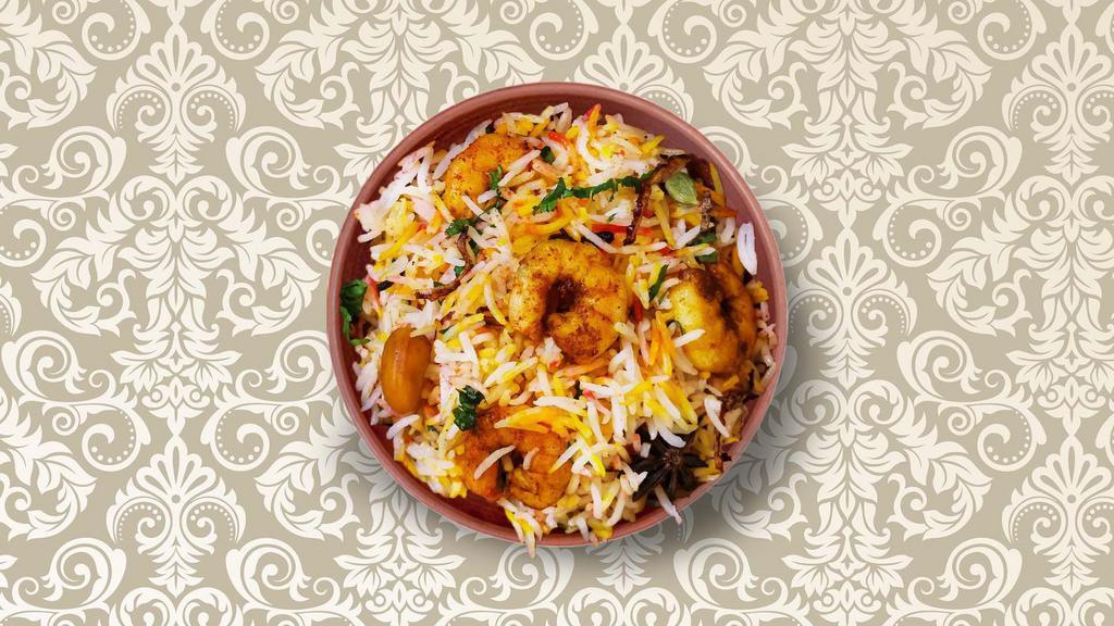 Clay Pot Shrimp Biryani · Long-grained rice dish layered with shrimp and cooked with our fresh herbs, homemade biryani masala, and Indian spices. Served with a side of yogurt raita and spicy curry sauce.