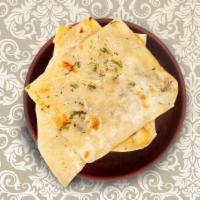 Garlic Naan · A refined flour leavened flatbread pressed with minced garlic and baked over an Indian clay ...