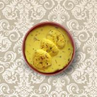Royal Rasmalai · Flattened balls of cheese curds soaked in milk and flavored with cardamom.