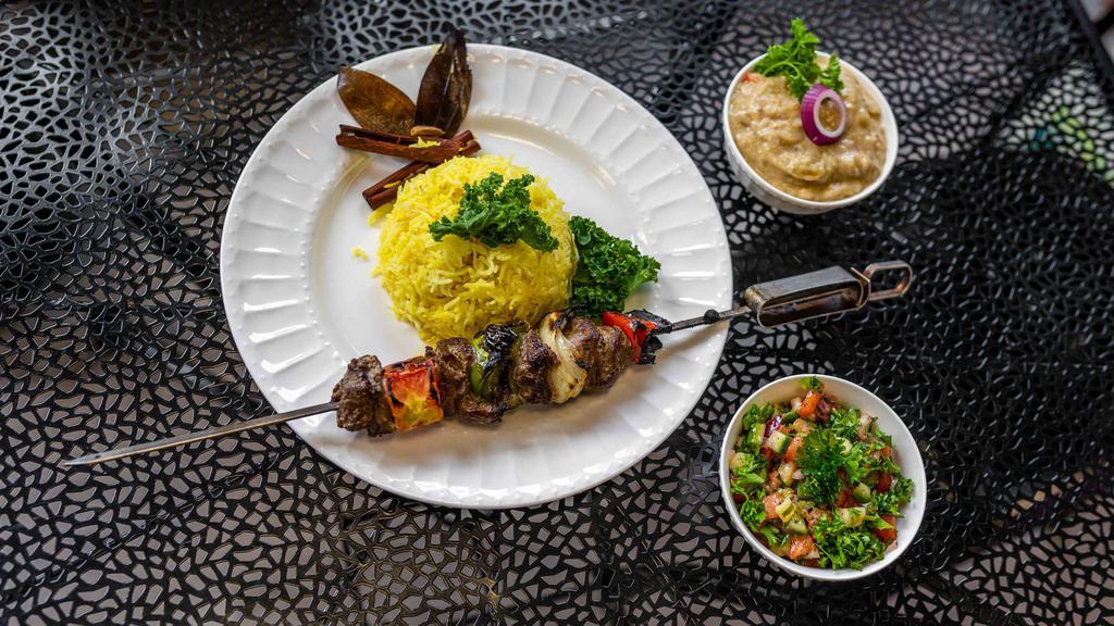Beef Shish Kabob Plate · Beef cubes marinated in onion, garlic, ginger, olive oil and other Mediterranean spices and grilled to perfection. Served on a bed of saffron rice, grilled vegetables and pita bread.