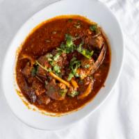 Goat Curry · Goat cooked in onion, tomato and spices.