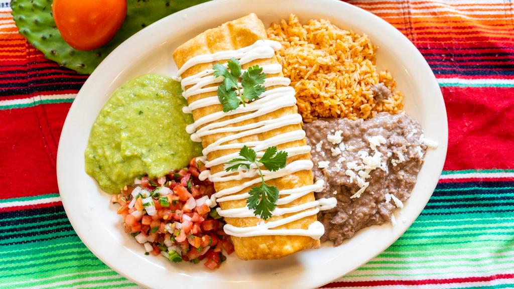 Chimichanga · Deep-fried cheese burrito, choice of steak, chicken, carnitas or al pastor, topped with sour cream, served with rice and refried beans, with guacamole and pico de gallo on the side.