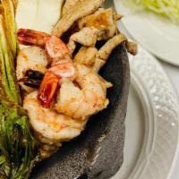 Molcajete · Grilled chorizo, shrimp, steak and chicken with fresh cheese and jalapeños, mixed peppers an...