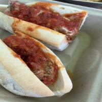 Meatball Parmigiana · Beef, pork, and veal meatballs, simmered in our San Marzano tomato sauce with cheese