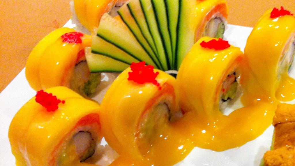 Mango Tango Roll · Crab stick and cucumber topped with salmon and mango, drizzled with mango sauce sweet.