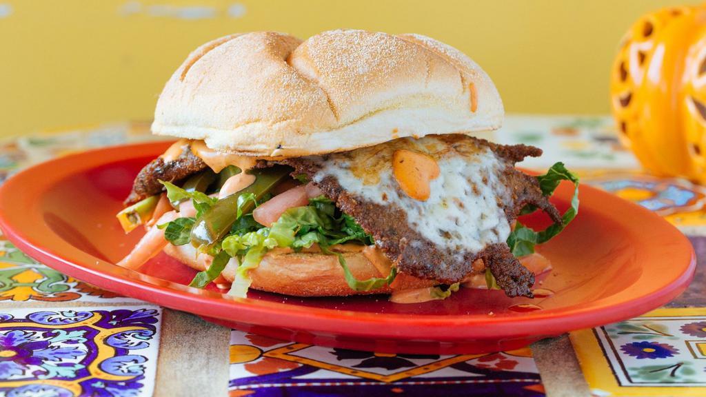 Cubana Torta · A Mexican sandwich with a combination of egg, chorizo and carnitas. With homemade chipotle mayonnaise, tomatoes, cheese, pickled jalapenos, and avocado put together on a Kaiser roll.