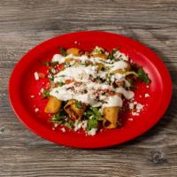 Tacos Dorados · Three crispy corn tortillas wrapped with potatoes and marinated chicken. Topped with lettuce...