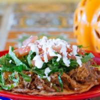 Tostadas · Fried corn tortillas, smothered with beans, topped with the meat, lettuce, tomatoes, cheese ...