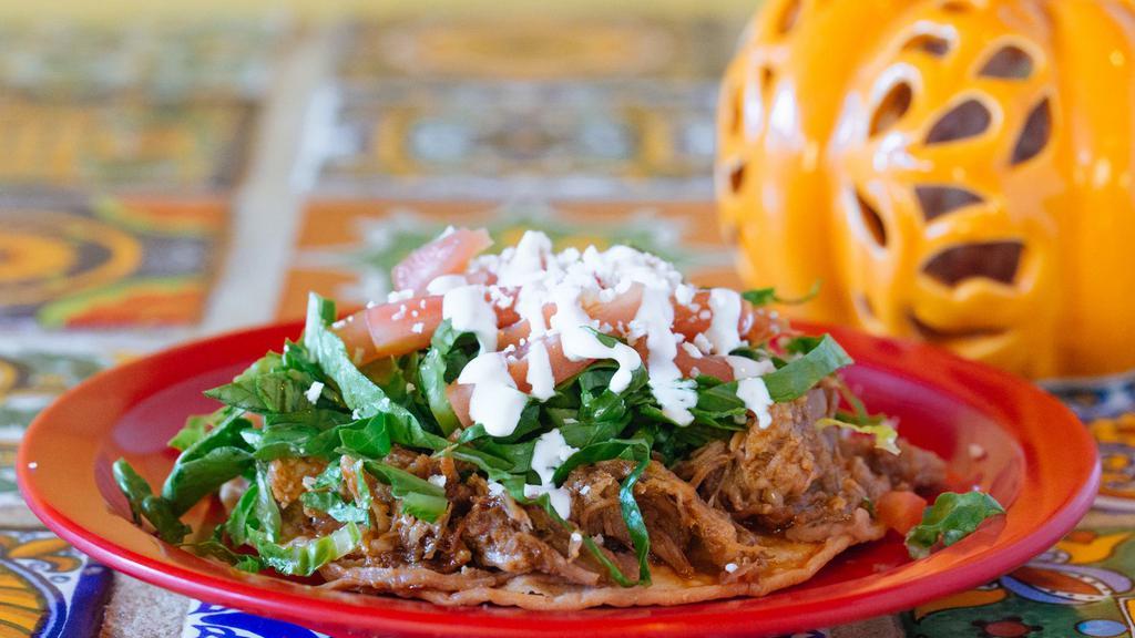 Tostadas · Fried corn tortillas, smothered with beans, topped with the meat, lettuce, tomatoes, cheese and sour cream.