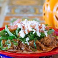 Vegetable Sope · Open face home-made corn tortillas smothered with beans. Topped with lettuce, tomatoes, chee...