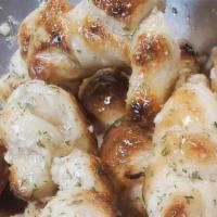 Garlic Knots · A classic Italian snack. Our garlic knots are strips of pizza dough tied in a knot,  baked t...