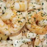 Seafood Fries · Salmon, Shrimp, cream sauce seasoned with Old bay & basil on a bed of fries. Topped with lig...