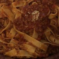 Fettuccine Bolognese · Fettuccine with traditional veal, beef and pork based tomato sauce.