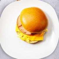 Ham, Egg & Cheese Breakfast Sandwich  · Ham, scrambled egg, cheddar cheese, sliced tomato and caramelized onions.Served on a long ro...