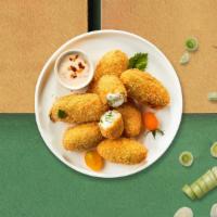 Jalapeño Poppers · (Vegetarian) Fresh jalapenos coated in cream cheese and fried until golden brown.