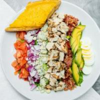 Chicken Cobb Salad · Fresh romaine and kale blend topped with bacon bits, tomatoes, red onion, blue cheese crumbl...