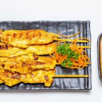 Chicken Satay (4) · Chicken on skewers marinated in Thai herb and coconut milk served with peanut sauce.