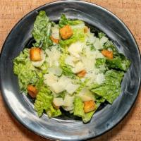 Caesar Salad · Hearts of romaine lettuce, homemade coal fired croutons and creamy Caesar dressing topped wi...