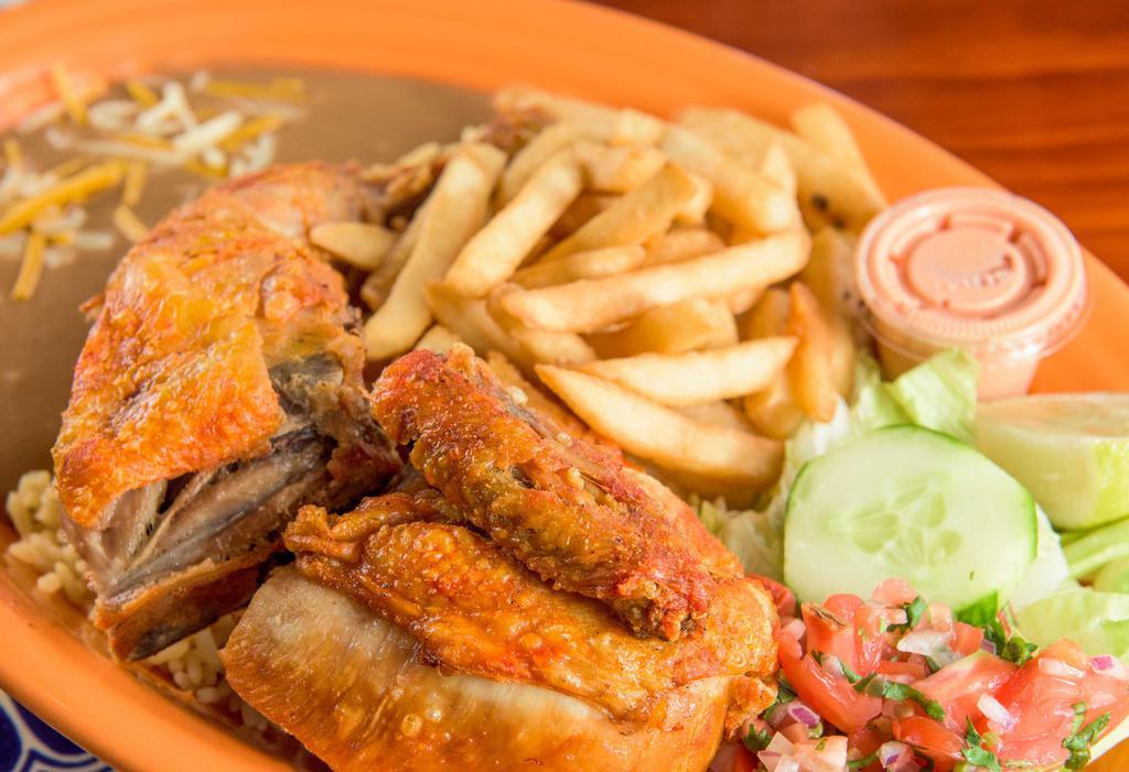 Fried Chicken · Pollo frito. Served with rice, beans, fries, and salad.