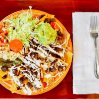 Nachos · Served with lettuce, refried beans, cheese, cream, guacamole, salsa and jalapehos. Beef, cho...