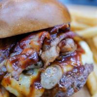 Bbq Mushroom Burger · Our 6oz juicy burger topped with mushrooms, bacon BBQ sauce and melted cheese served on a fr...