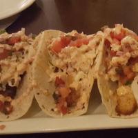Ultimate Fish Tacos · warm corn tortilla, chiffonade lettuce, Cajun-blackened salmon and shrimp, pico de gallo, ch...