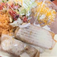 Burritos Fajita · 2 burritos stuffed with grilled chicken or steak, onions and bell peppers. Served with tomat...