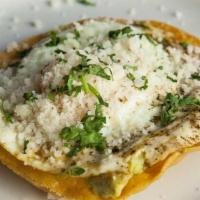 Fried Egg Tostada · avocado / frijoles negros / cilantro / cotija