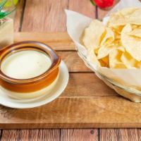 Queso Blanco · Spicy white cheese dip. Served with chips.